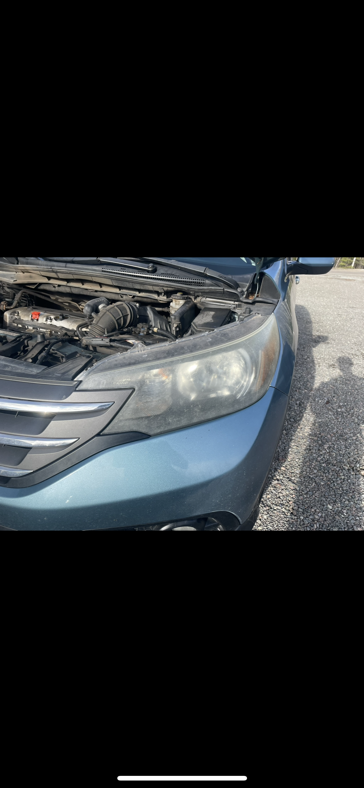 Cloudy headlight before restoration on teal Honda CR-V