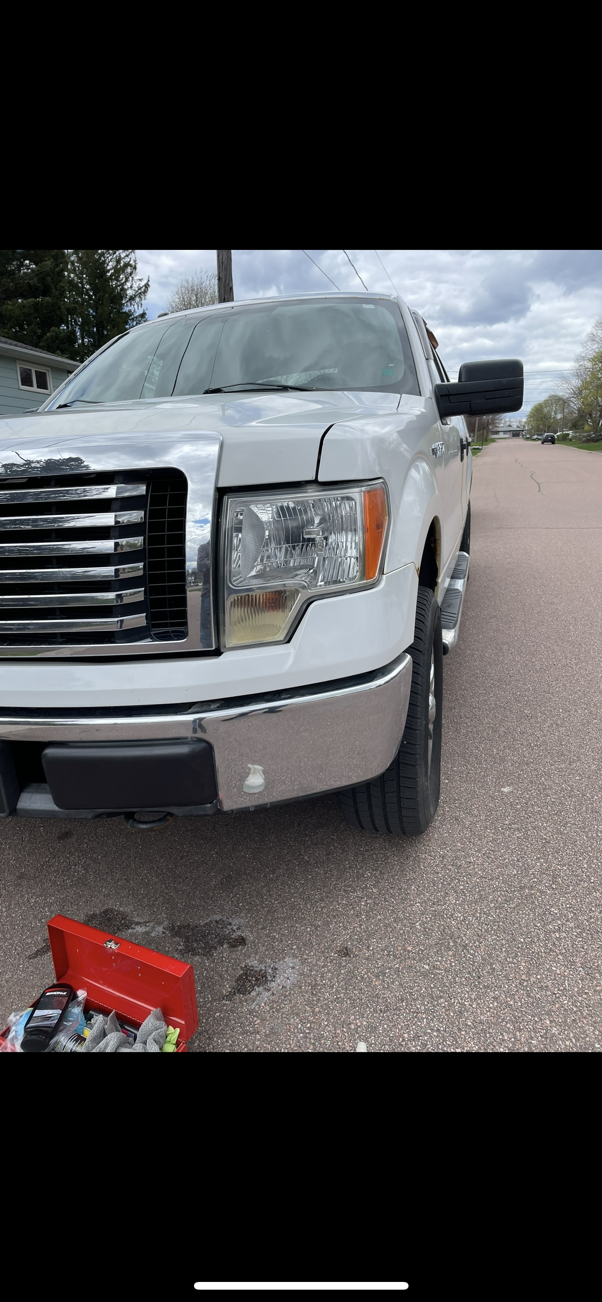 Clear headlight after restoration on white Ford F-150